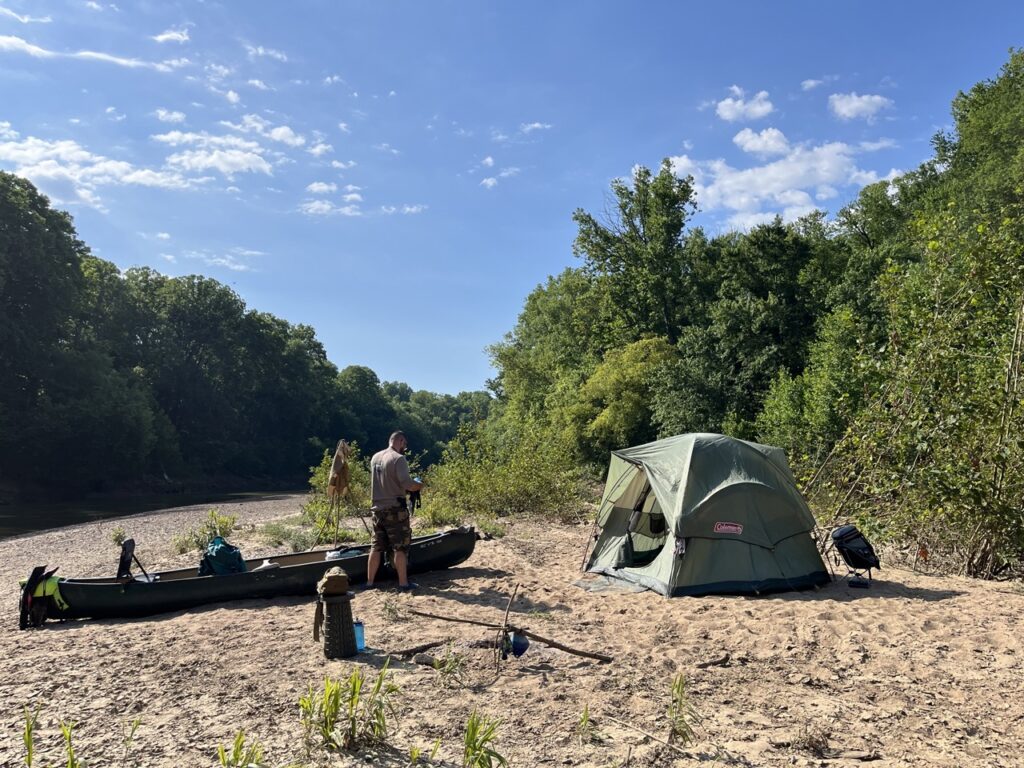 canoe camping on riverbank